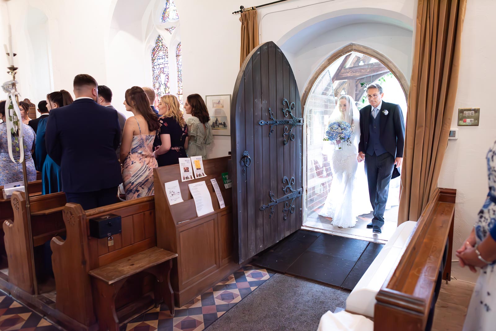 Lily arrives at St Nicholas Church in Iford accompanies by her father before her wedding to Callum.