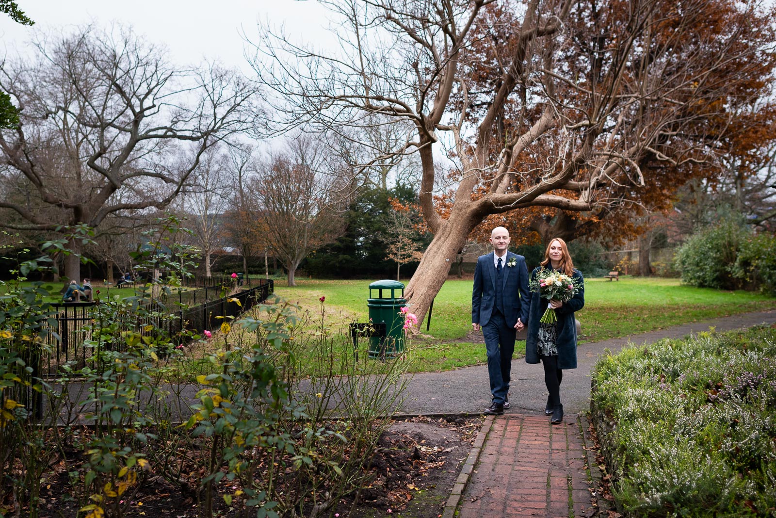 Melanie and Ryan walk through Southover Grange after their wedding at Lewes Register Office.