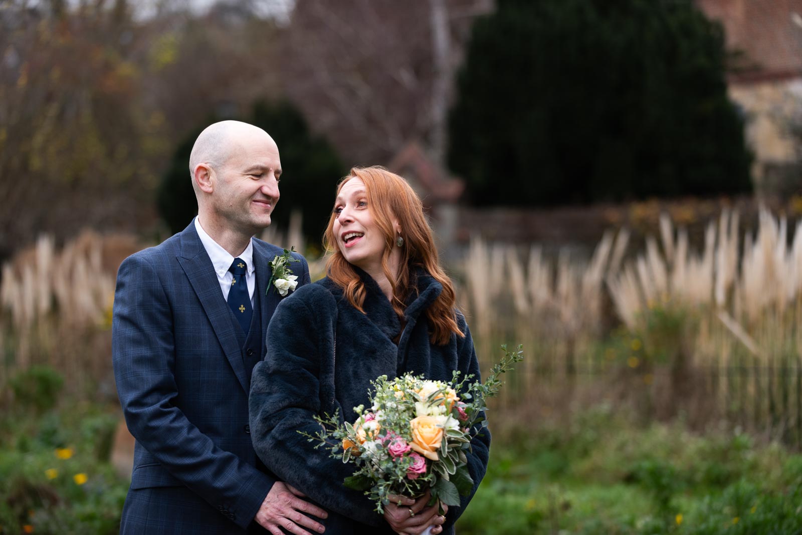 Melanie and Ryan smile at each other in Southover Grange after their wedding at Lewes Register Office.