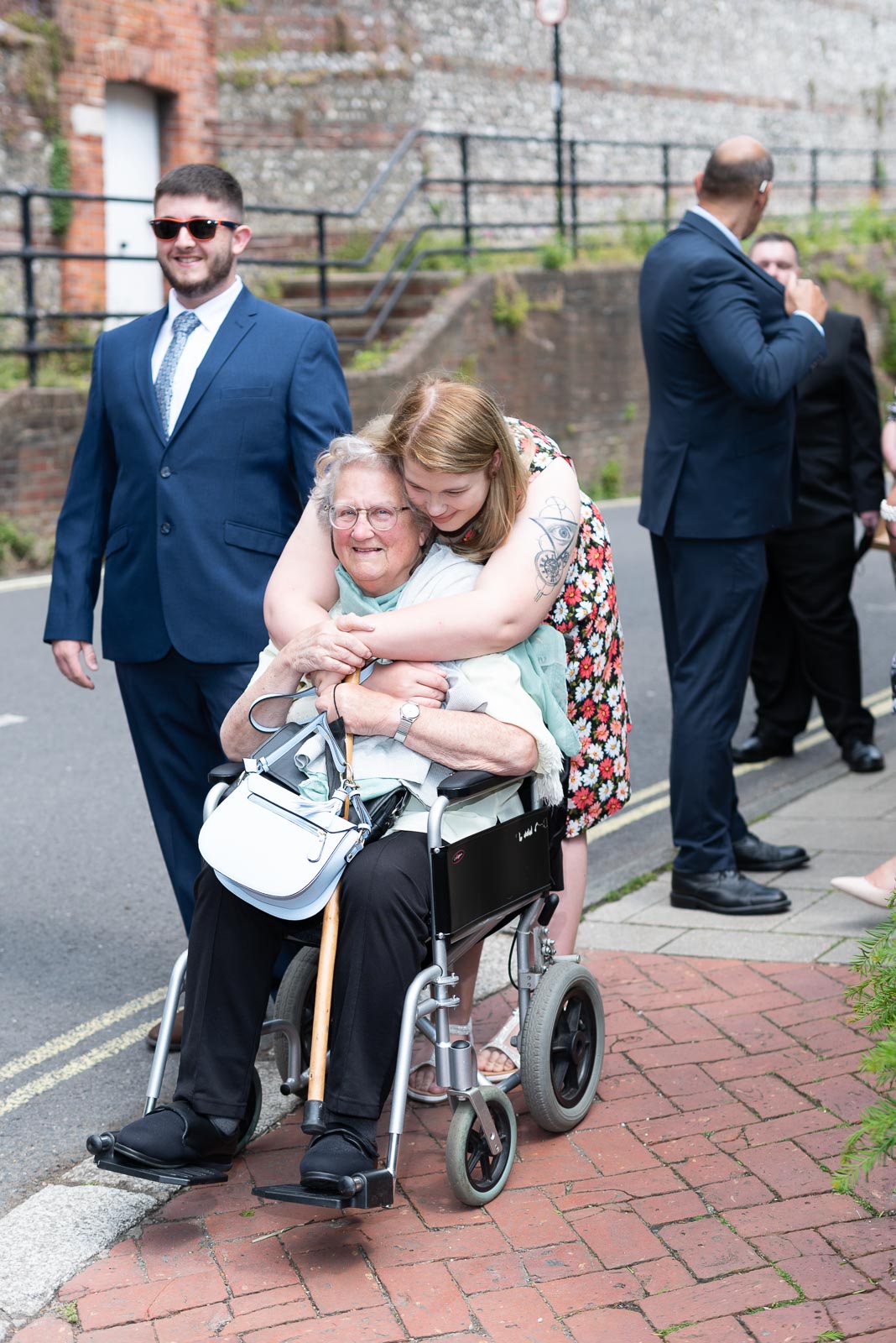 Guests embrace before Sophie and Nathan's wedding in the Ainsworth Room at Lewes Register Office.