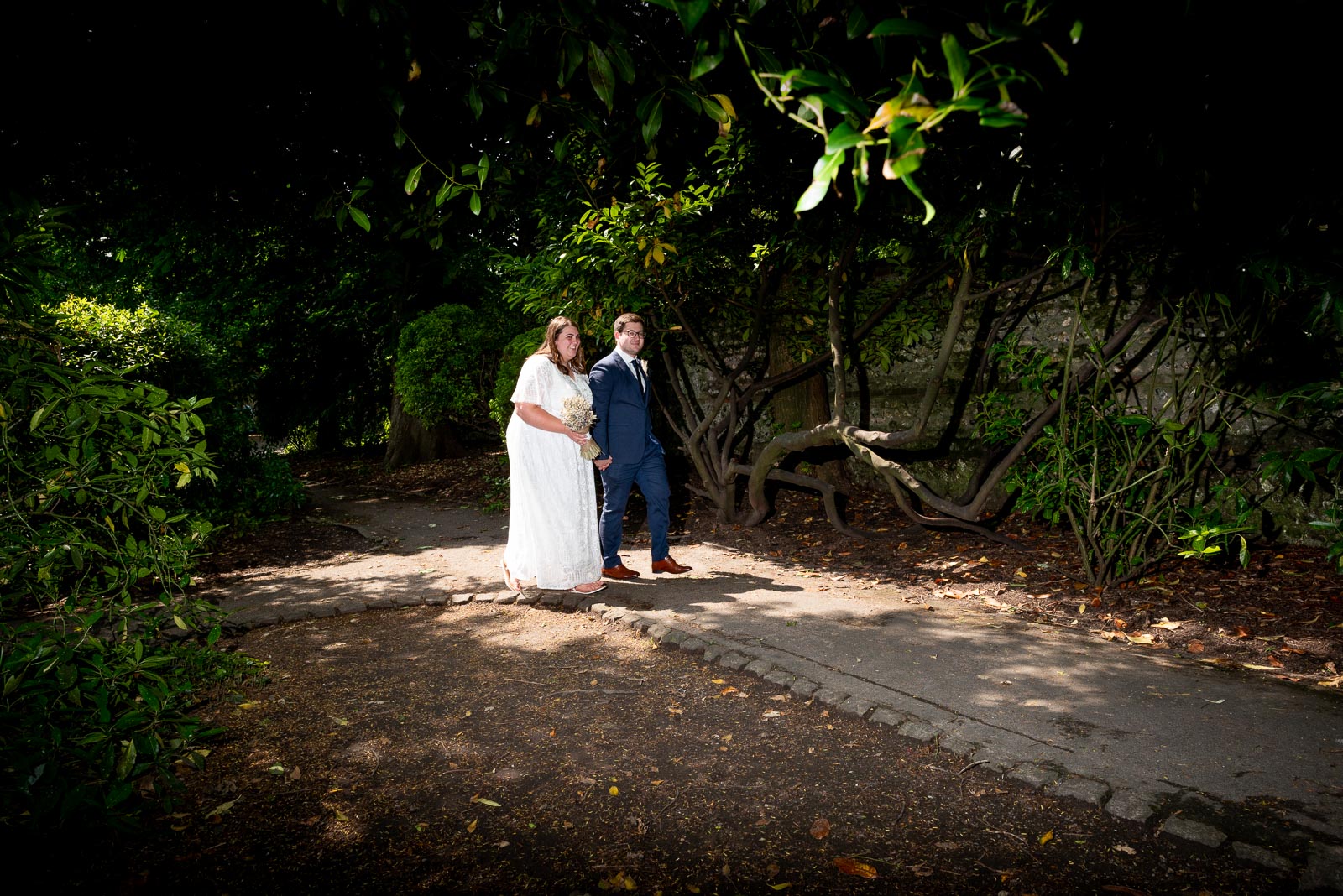 Sophie and Nathan walk through Southover Grange after their wedding in Lewes Register Office.