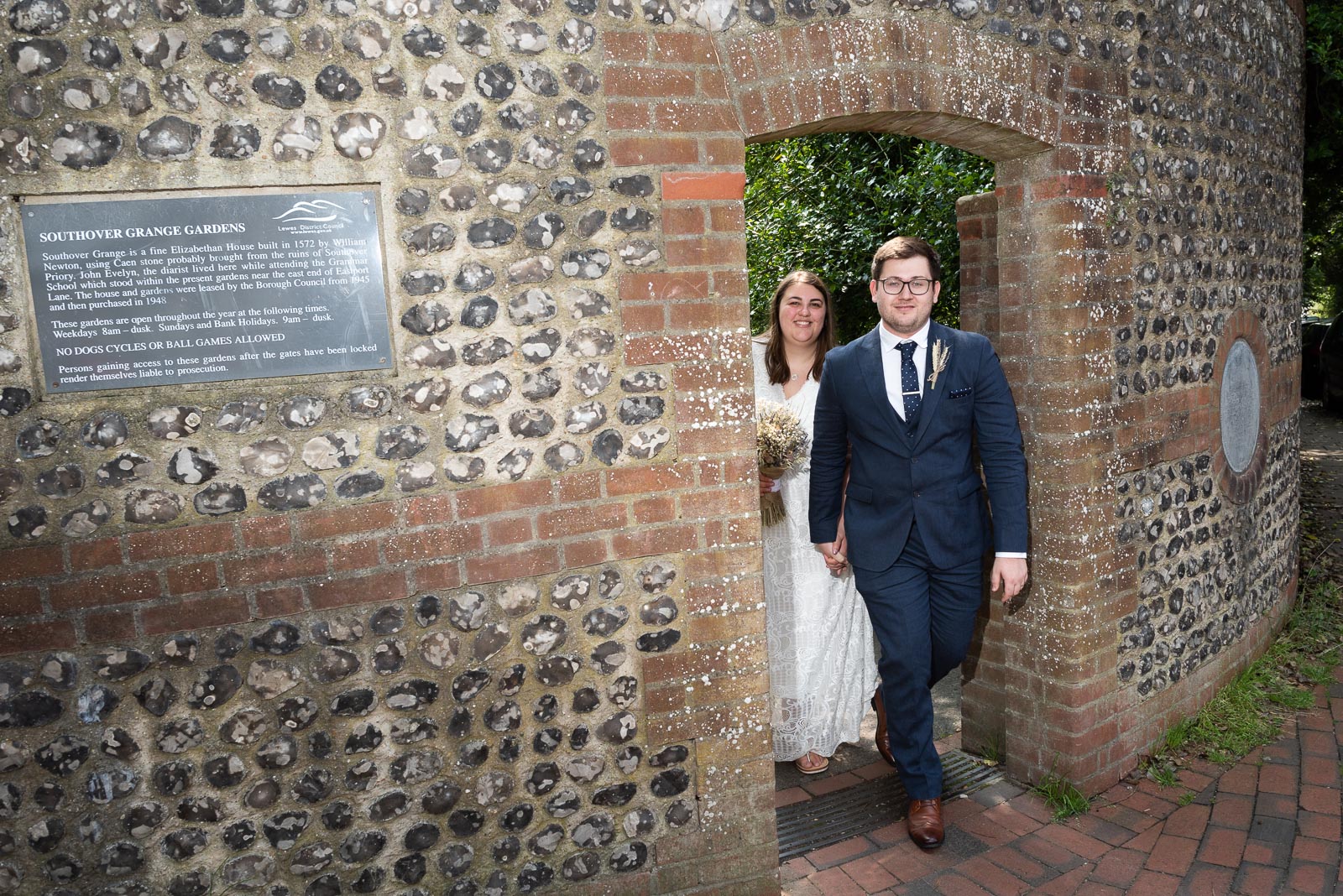 Sophie and Nathan walk out of Southover Grange after their wedding in Lewes Register Office.