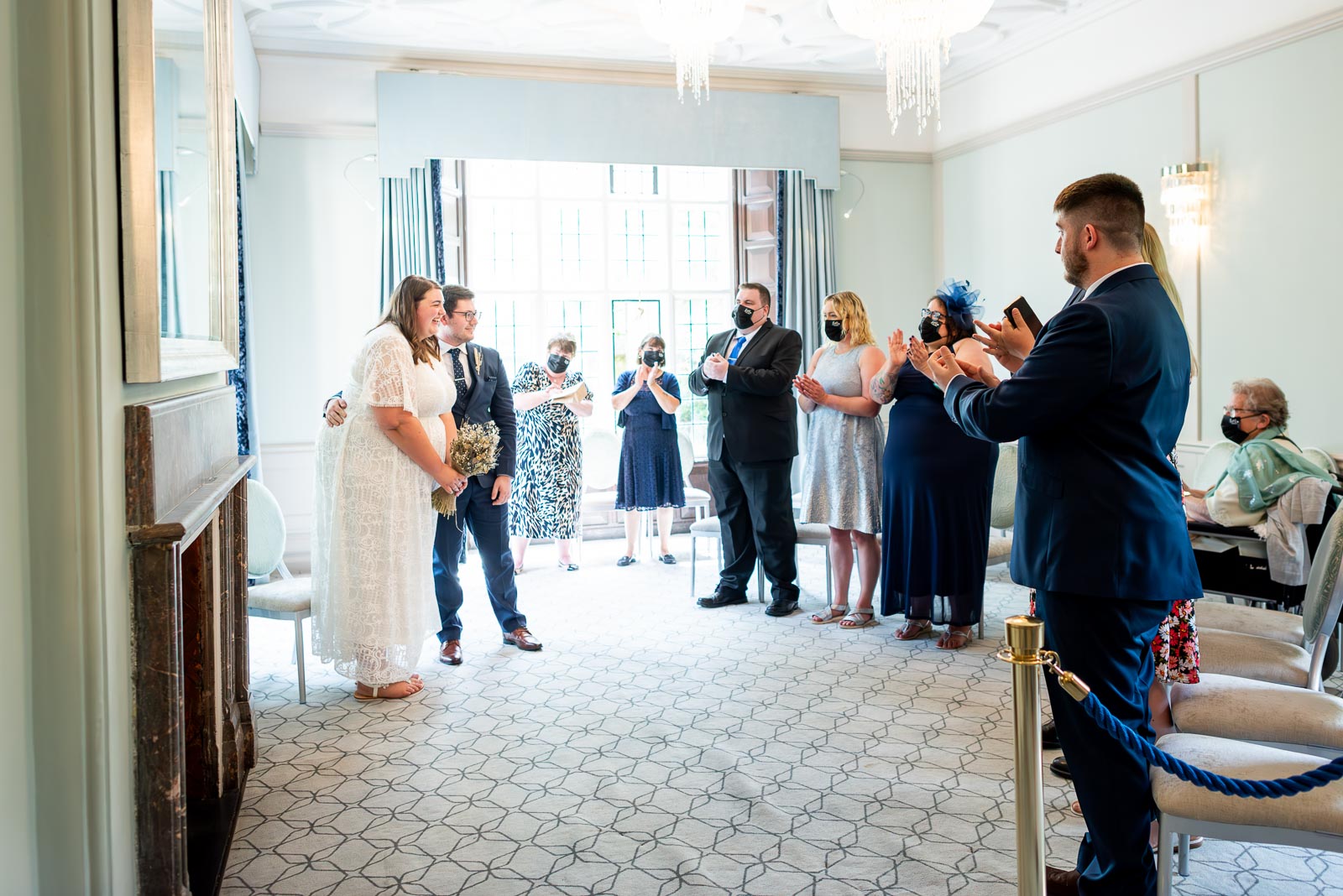 Guests clap after Sophie and Nathan are announced husband and wife in the Ainsworth Room in Lewes Register Office.