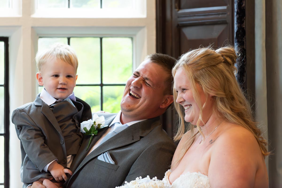 Eliana, Jacob and their two year old son enjoy a funny moment in the Ainsworth Room at Lewes Register Office at their Wedding.