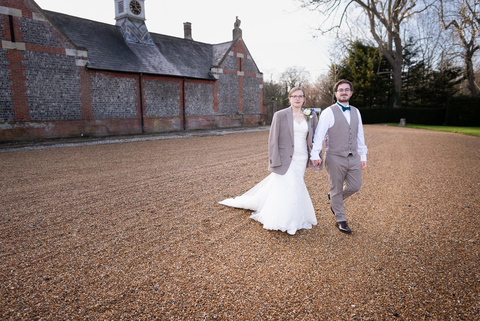 Lewis and Stephanie walk outside Folkington Manor near Polegate with Stephanie wearing Lewis's jacket.