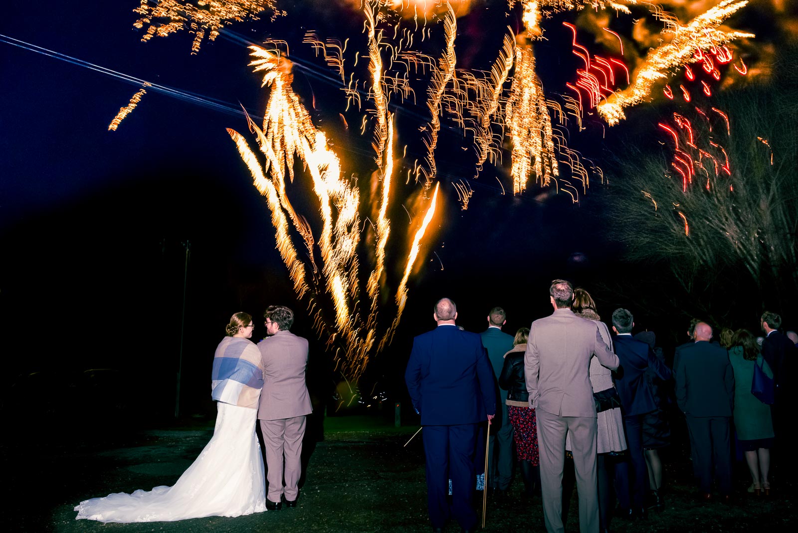 Lewis, Stephanie and their wedding guests enjoy a firework display in the gardens at Folkington Manor near Polegate.
