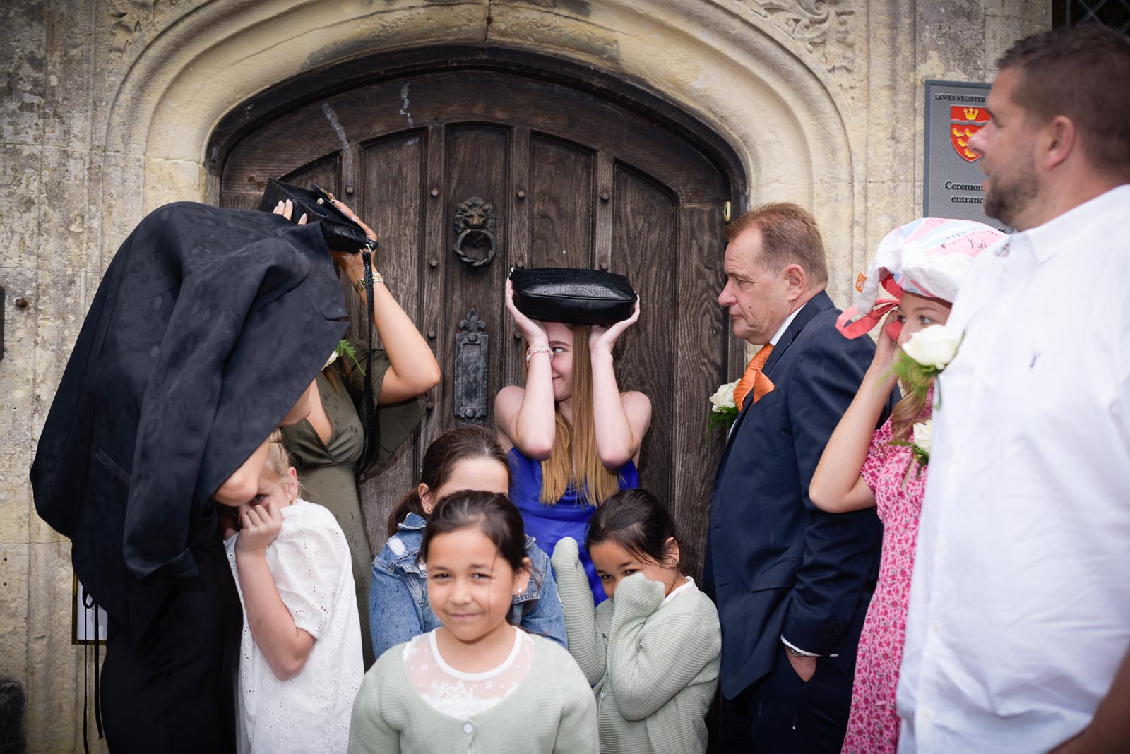 Martin and his family try to stay dry during a sudden rainstorm outside Lewes Register Office before his wedding to Joanne.