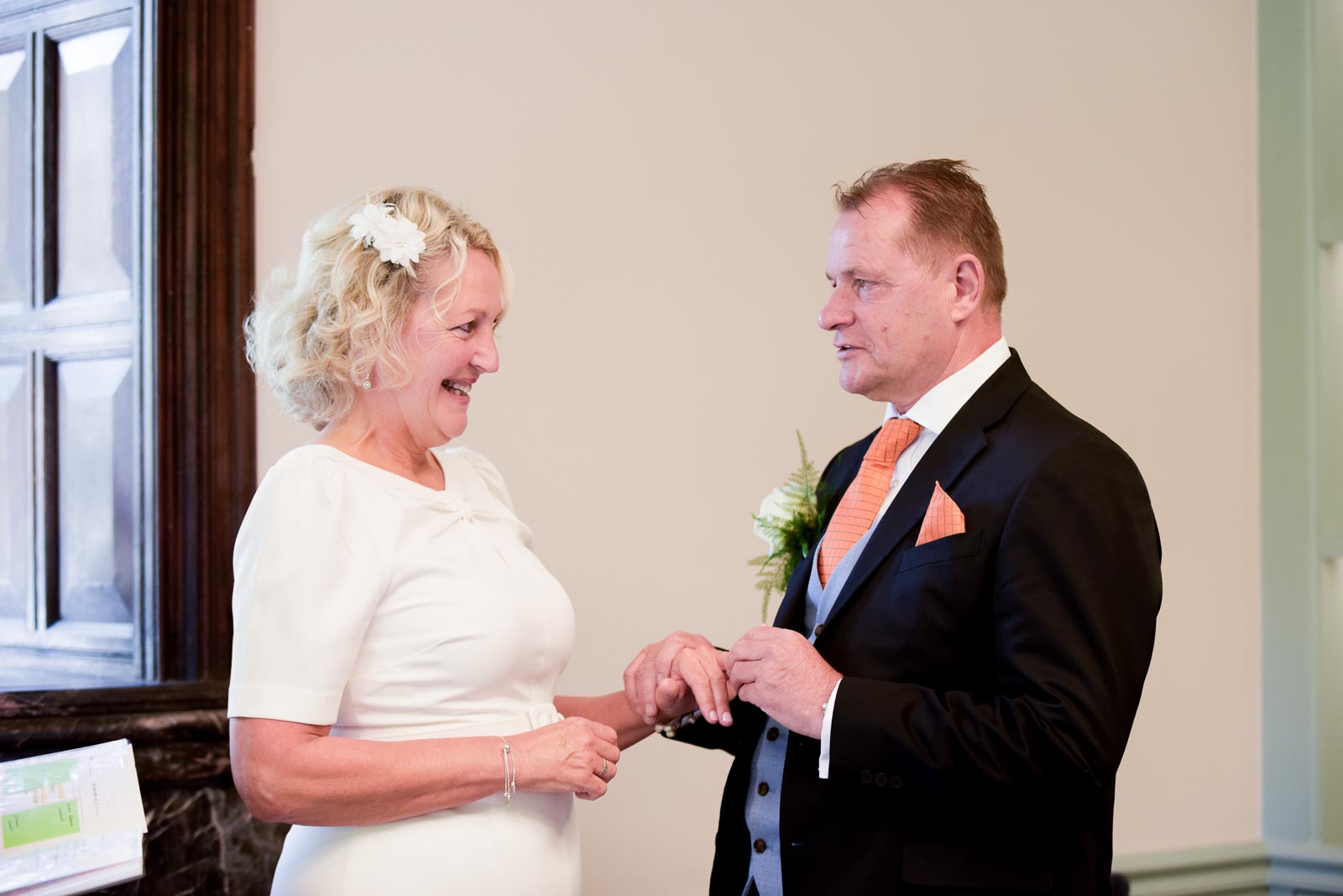 Martin holds it together with a tear in his eye whilst putting a ring on Joanne's finger in the Evelyn Room at Lewes Register Office.