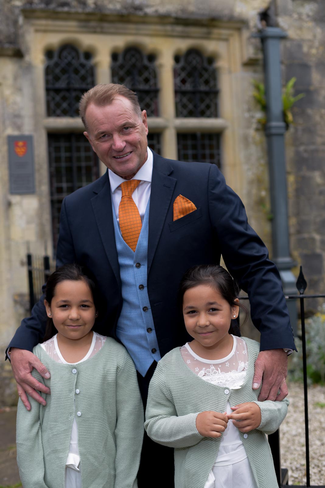 Martin poses with his twin seven year old grand daughters at the front entrance of Lewes Register Office before his wedding to Joanne.