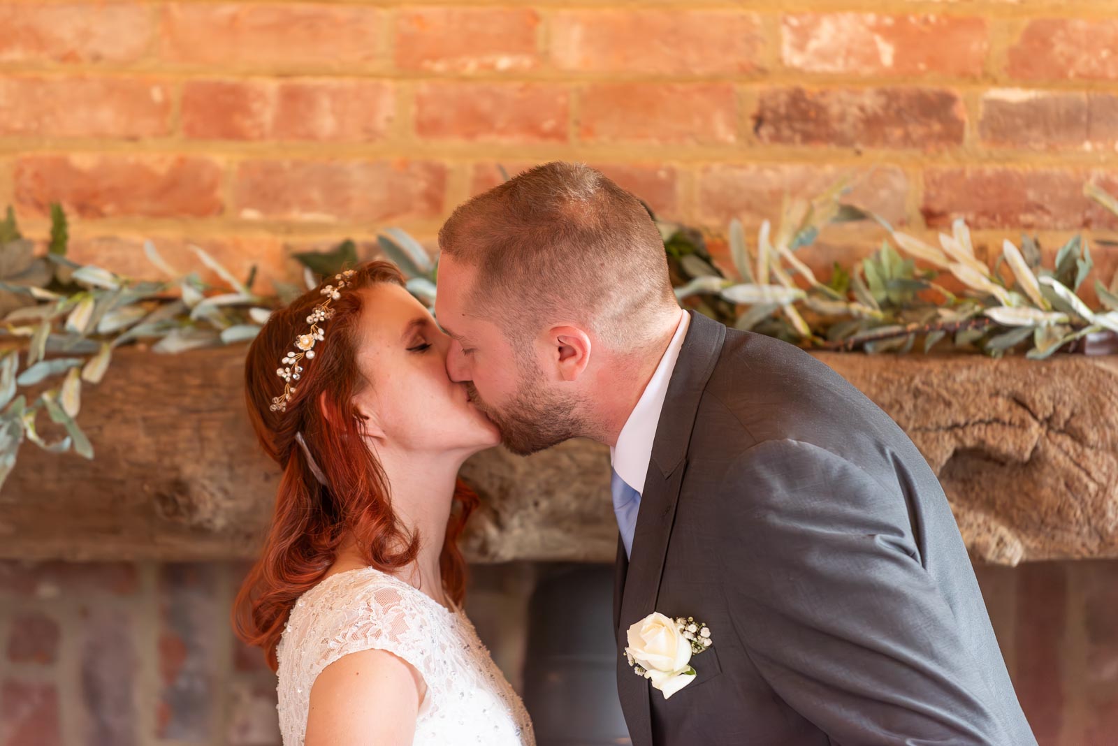 Adrienn and Lee embrace at the top of the aisle at Milwards Farm Estate near Lewes.