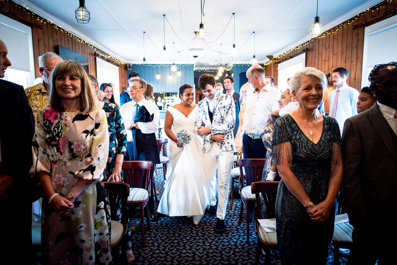 Olivia and Edward arrive on the wedding aisle of the function room at The Royal Oak in Lewes surrounded by friends and family.