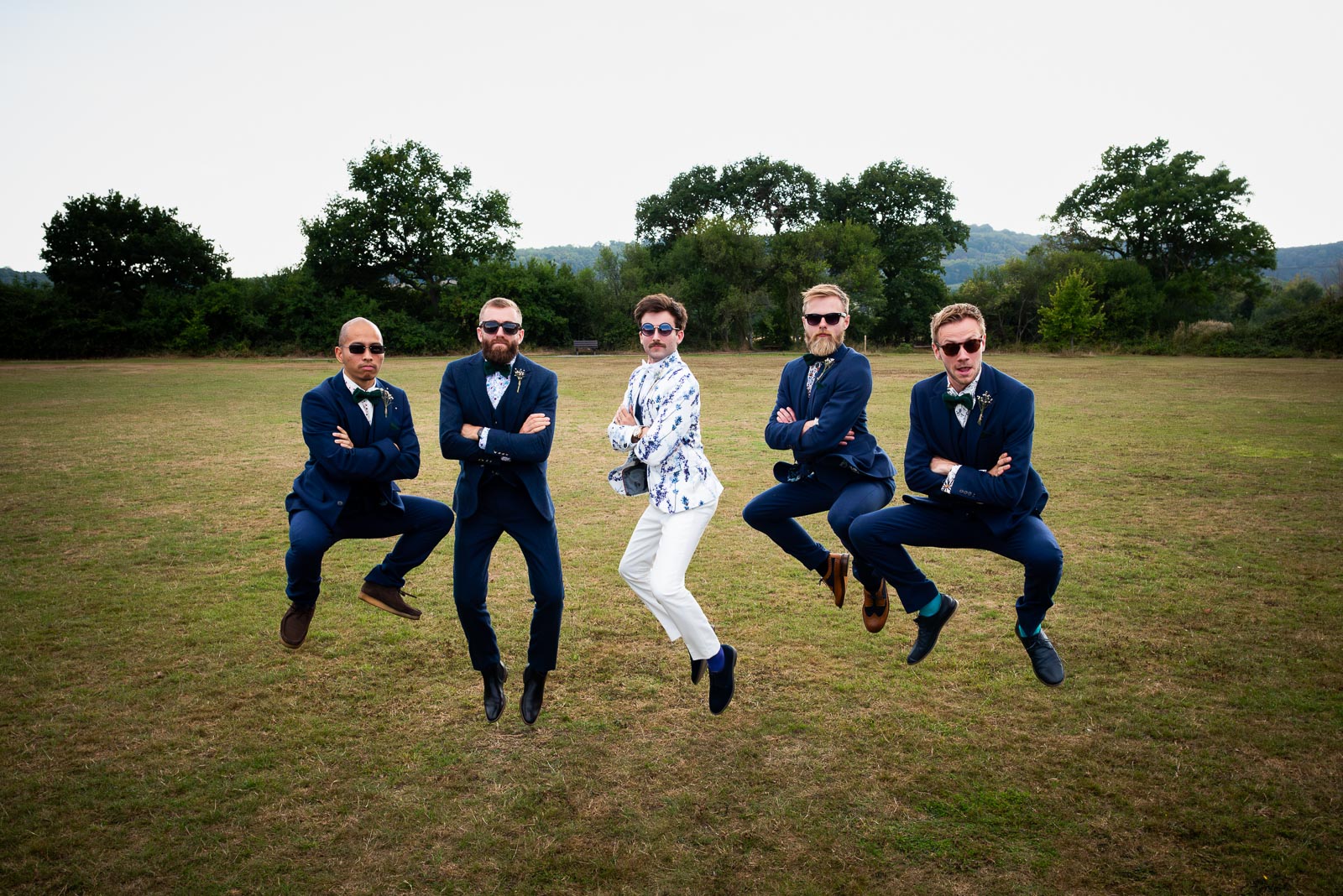 Edward and his Groomsmen pull off an impressive jumping pose during the Wedding Reception at Beechwood Hall & Rural Park. 