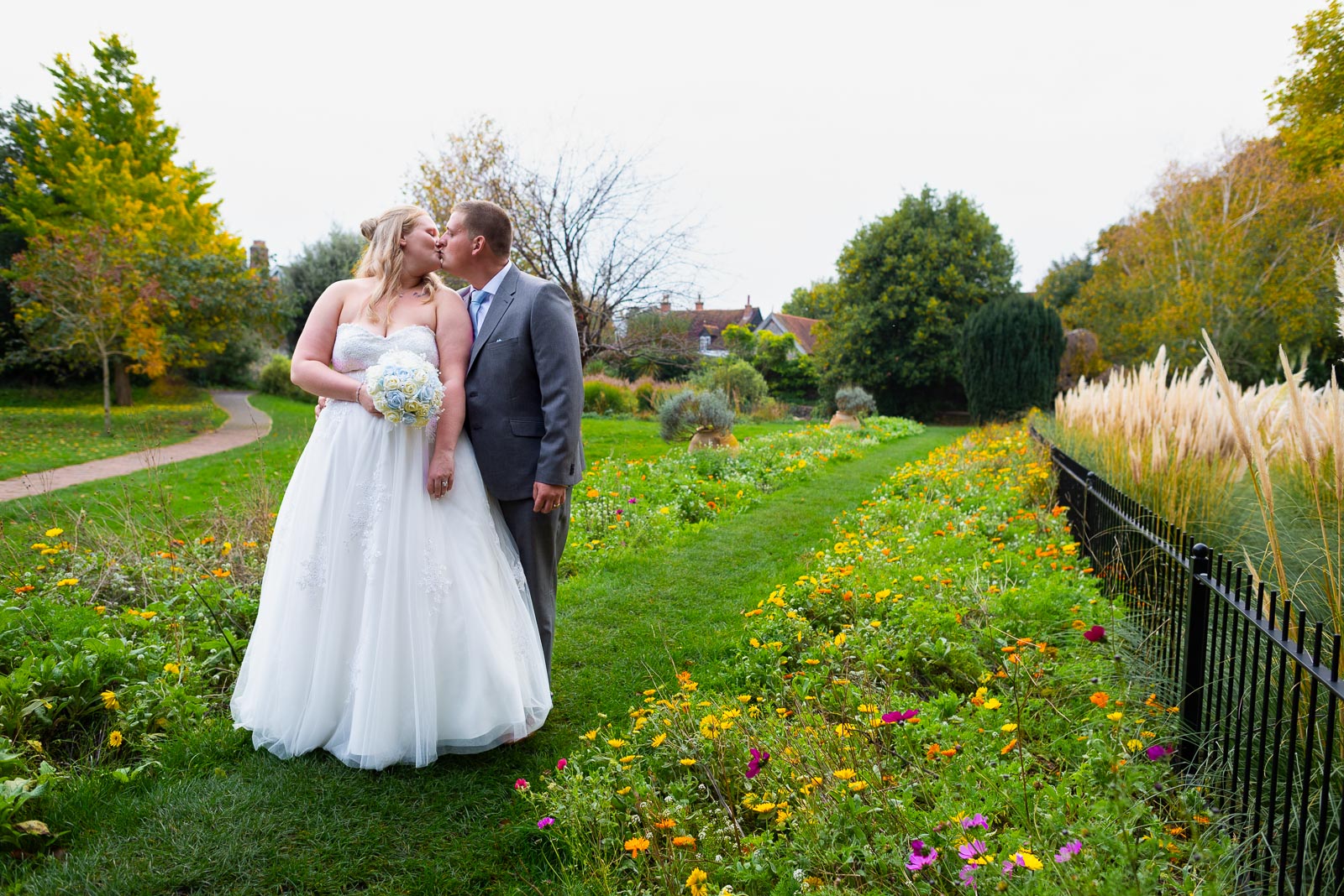 Eliana and Jacob embrace in Southover Grange after their wedding at Lewes Register Office.