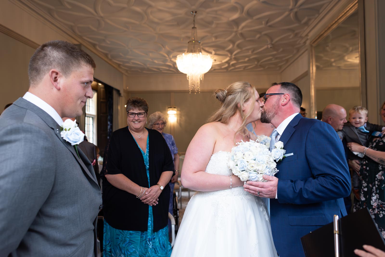 Eliana kisses her father after arriving at the top of the aisle in the Ainsworth Room at Lewes Register Office before her Wedding to Jacob.