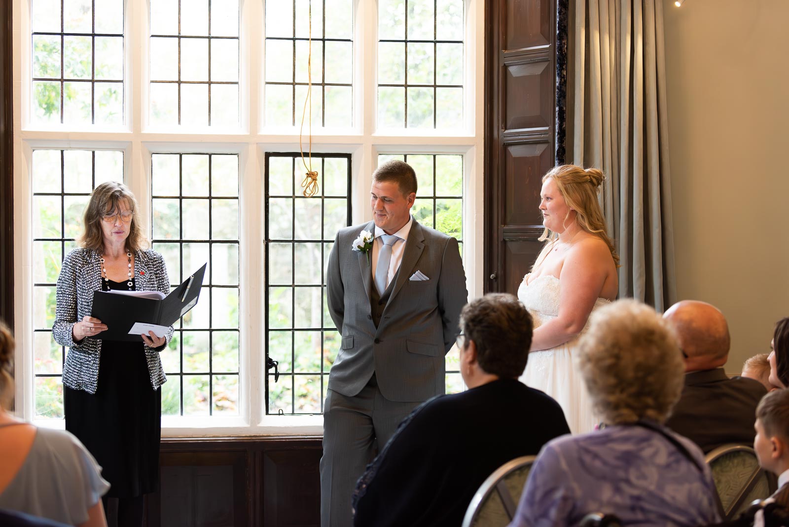 Eliana and Jacob exchange vows with their two year old son at the top of the aisle in the Ainsworth Room at Lewes Register Office.