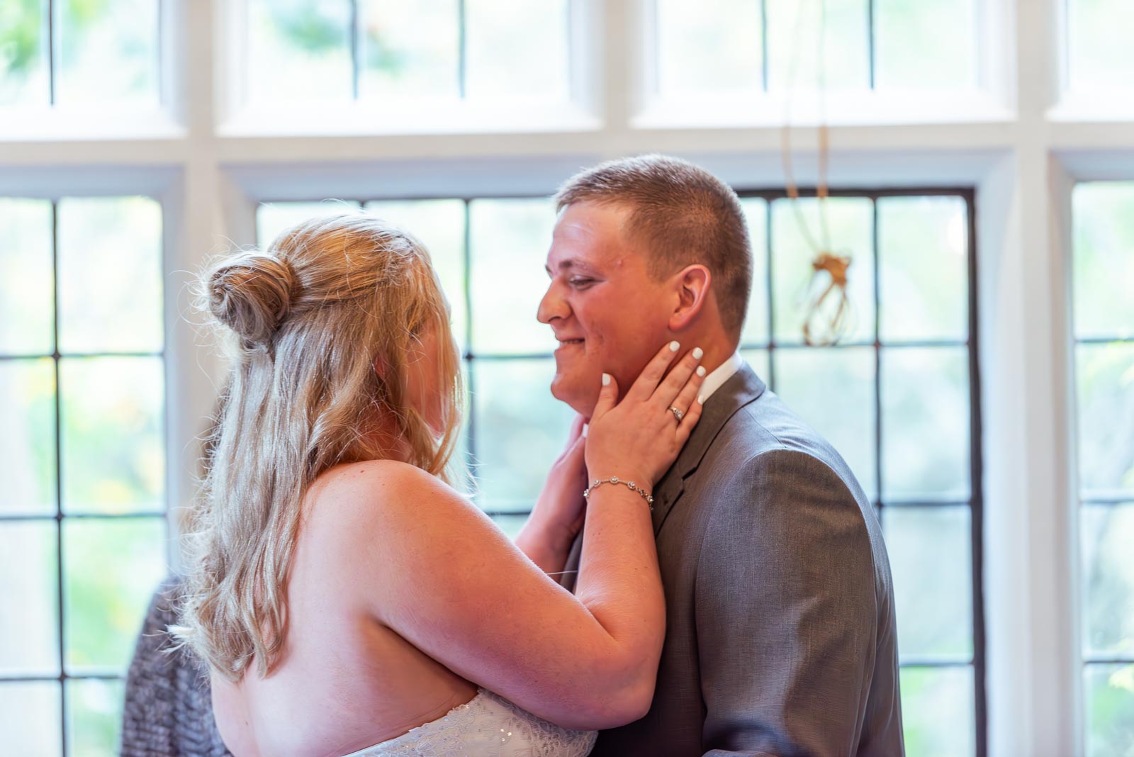 Eliana and Jacob embrace after exchanging vows at the top of the aisle in the Ainsworth Room at Lewes Register Office.