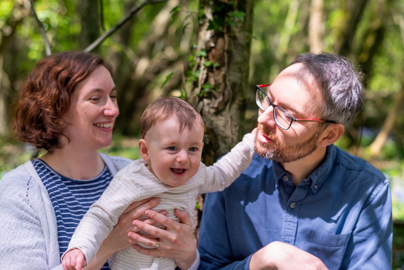 Alasdair enjoys the a happy moment with his mum and dad among the bluebells at Battle Great Woods