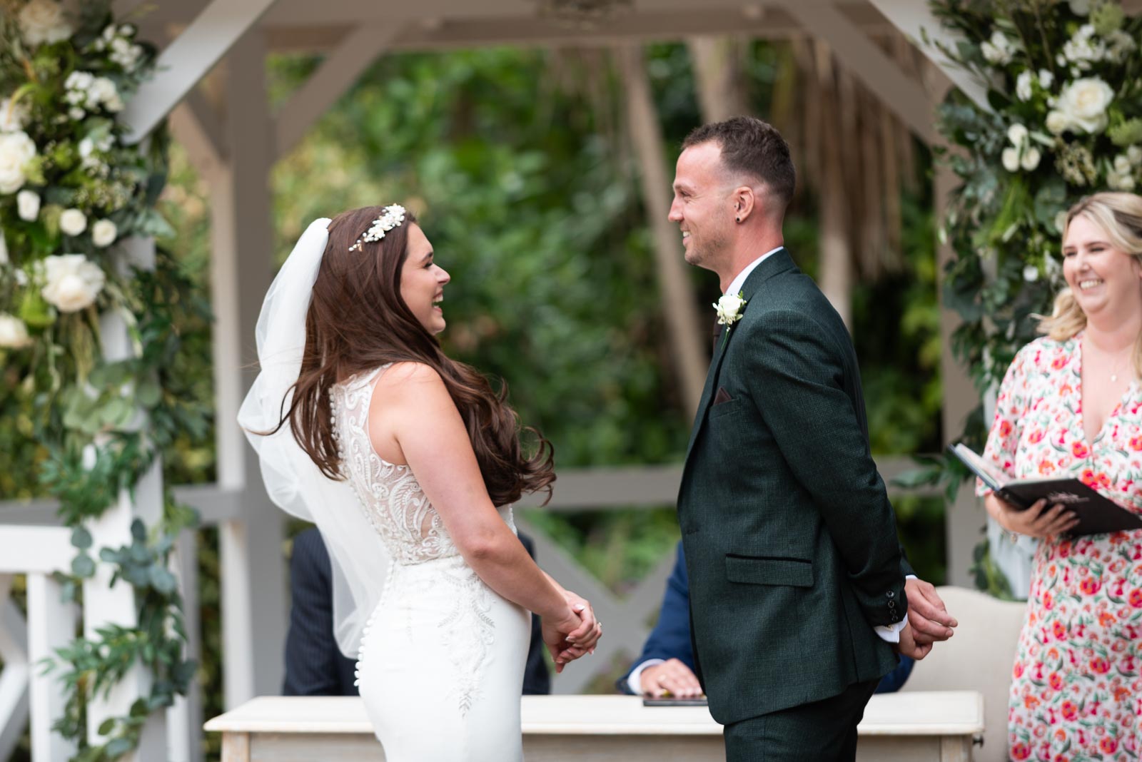 Natalie and Dean enjoy a funny moment during their wedding at the Gazebo in the garden at Pelham House Hotel, Lewes.