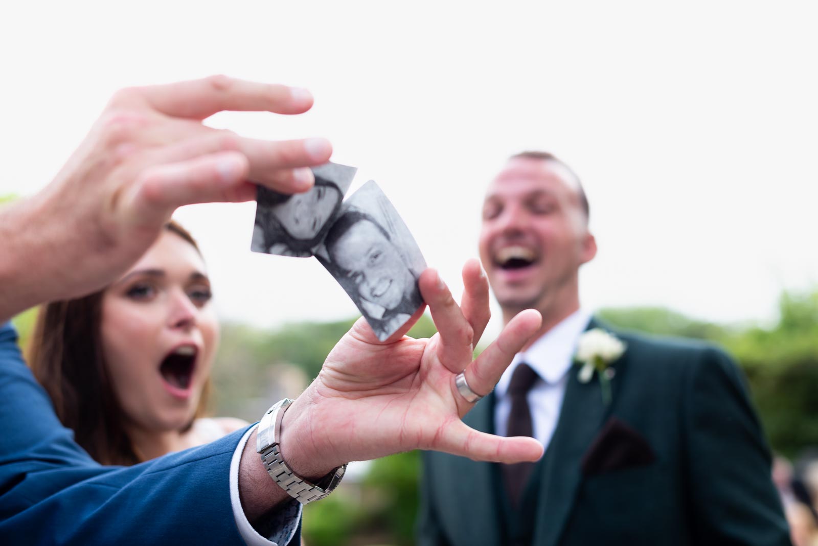 The magician performs a card trick for Natalie and Dean at their wedding in Pelham House Hotel, Lewes.