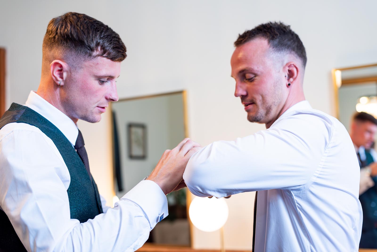 Dean's best man helps him with his cufflinks before his wedding to natalie at Pelham House Hotel, Lewes.
