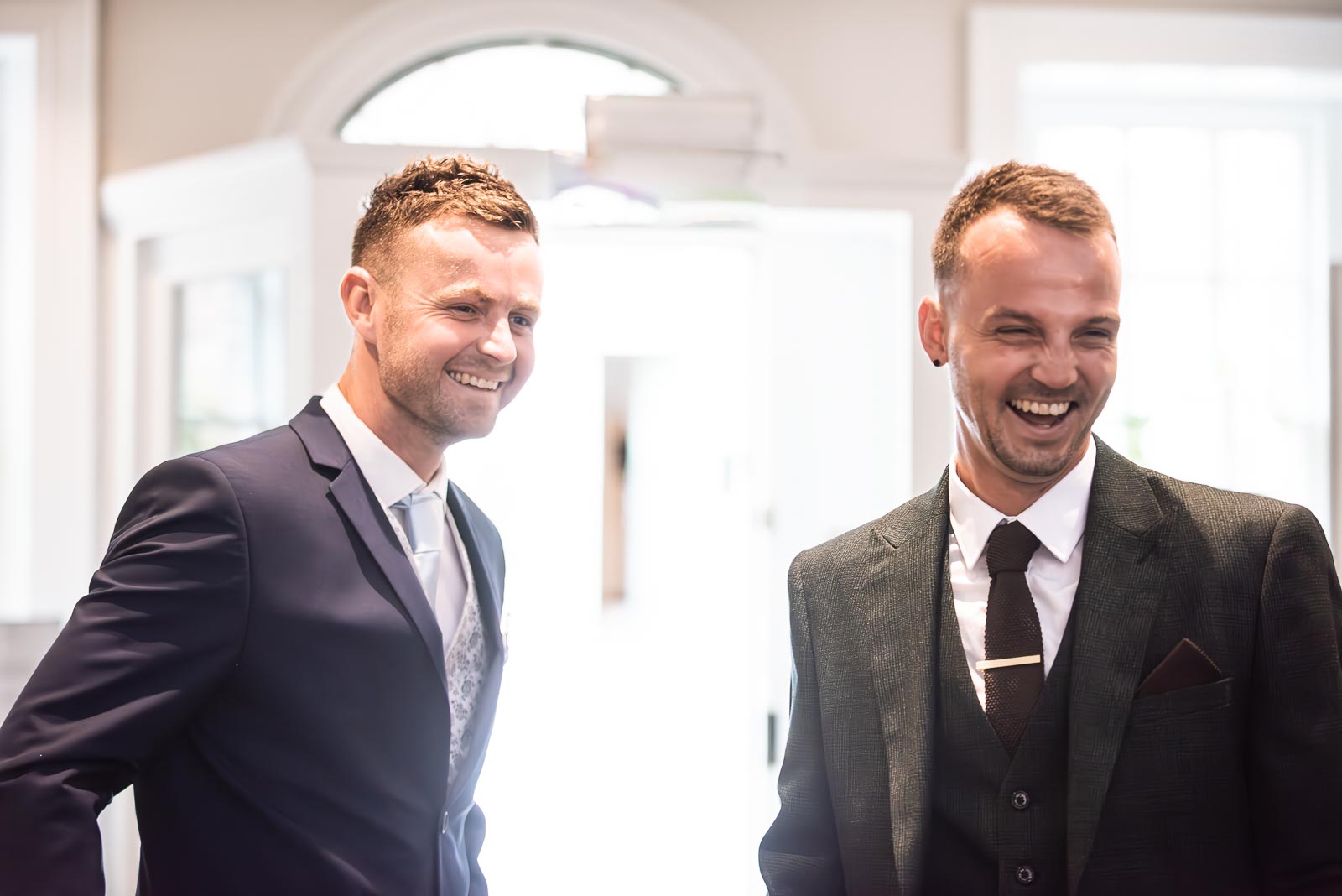 Dean and a guest enjoy a funny moment at the front door of Pelham House Hotel, Lewes before his wedding to Natalie.