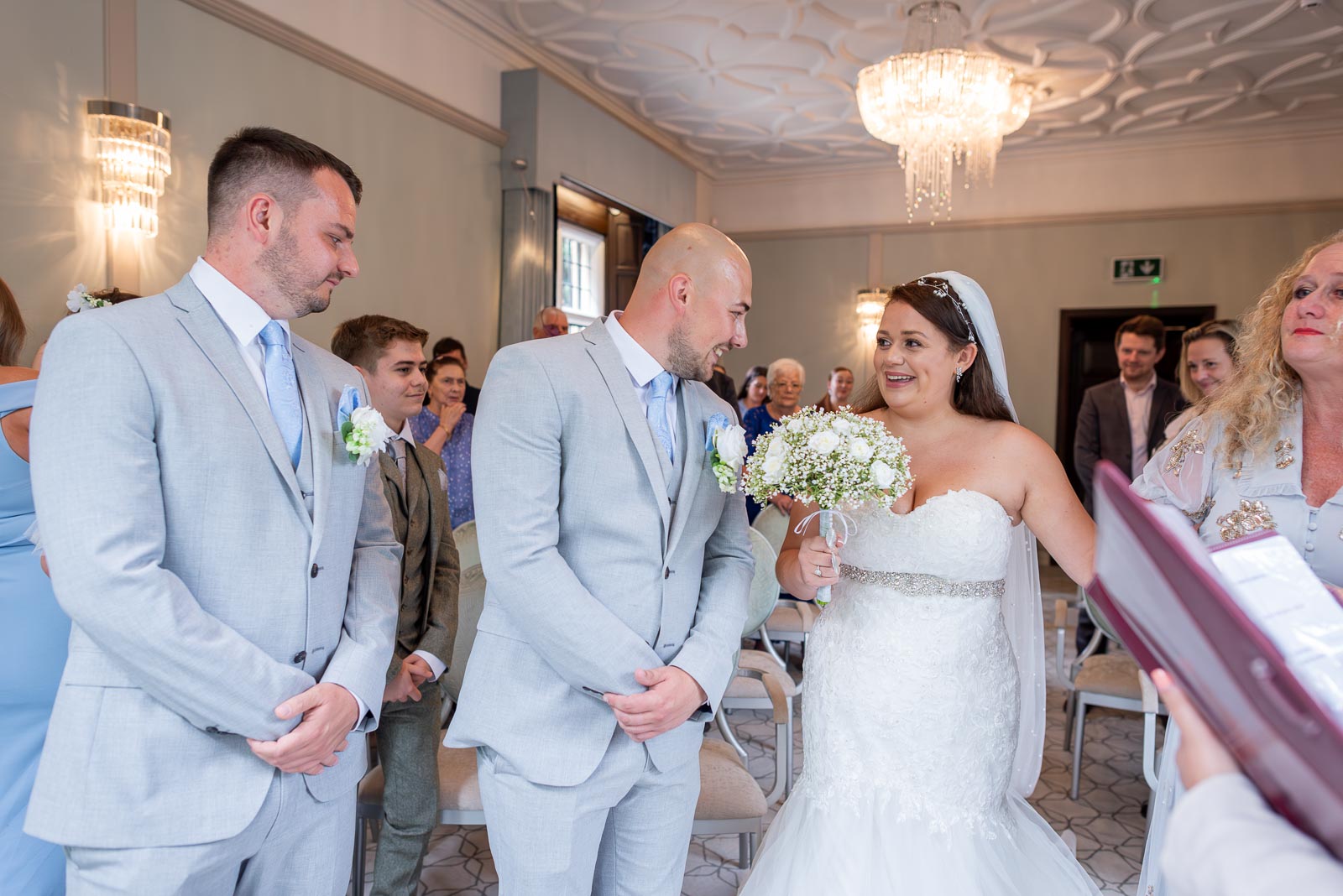 Billy greets Soraya with a smile at the top of the aisle in the Ainsworth Room, Lewes Register Office.