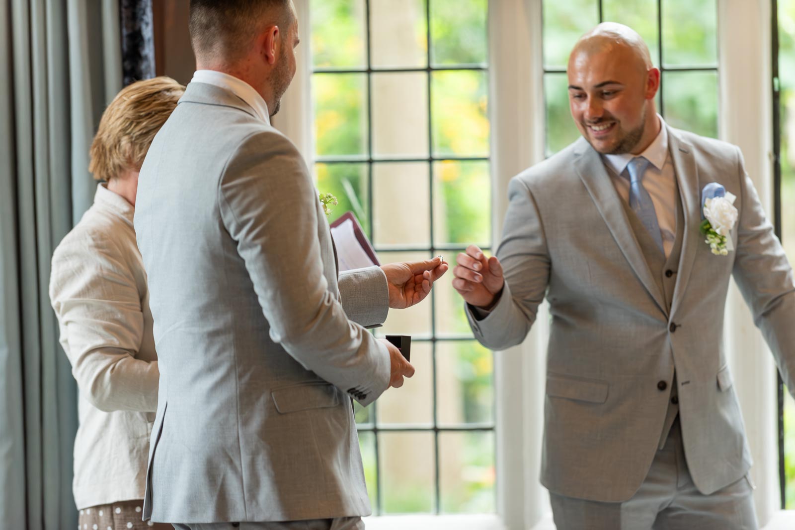 Billy's best man presents him with the ring in the Ainsworth Room, Lewes Register Office to give to his bride Soraya.