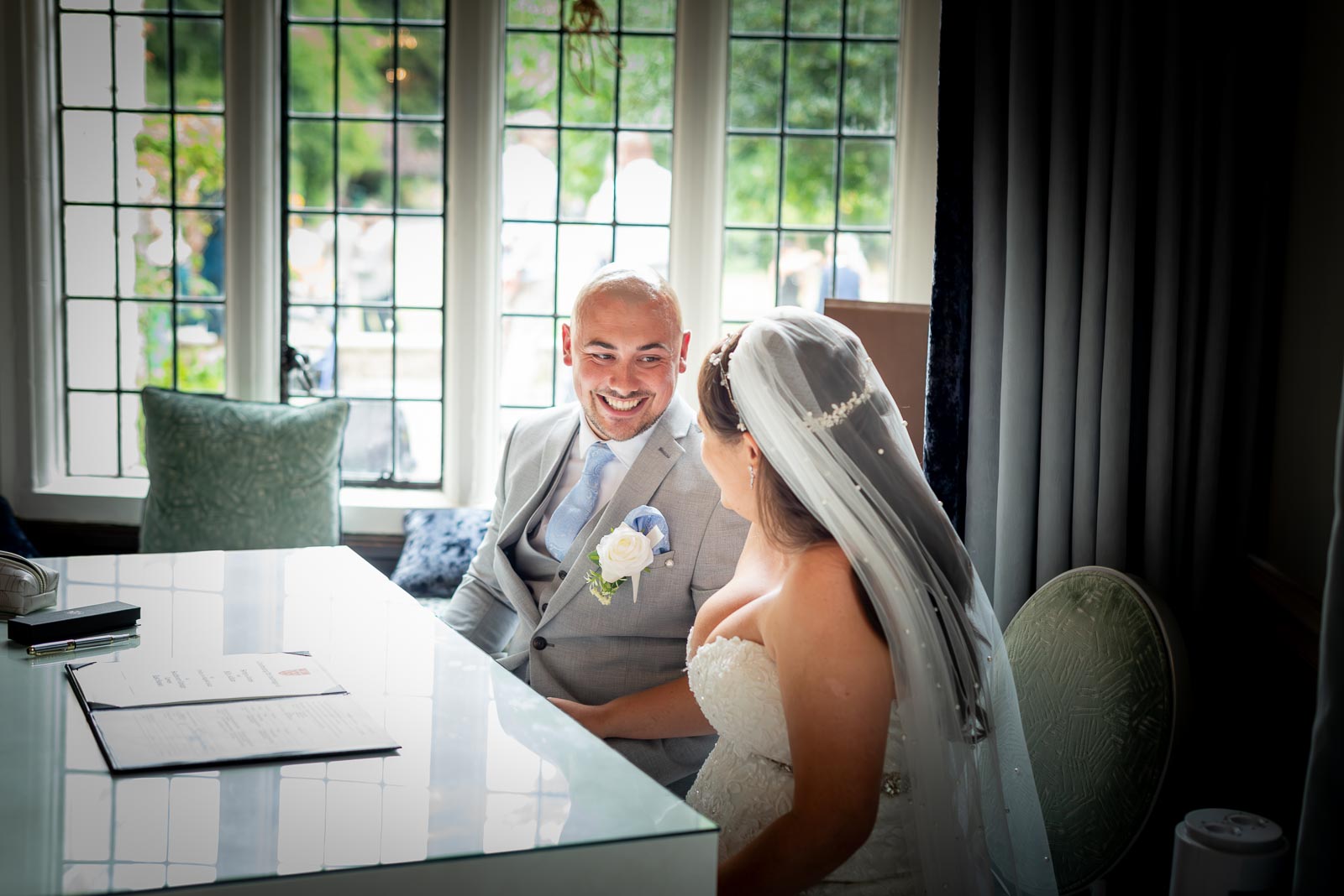 Billy smiles at Soraya after signing the register in the Ainsworth Room, Lewes Register Office.