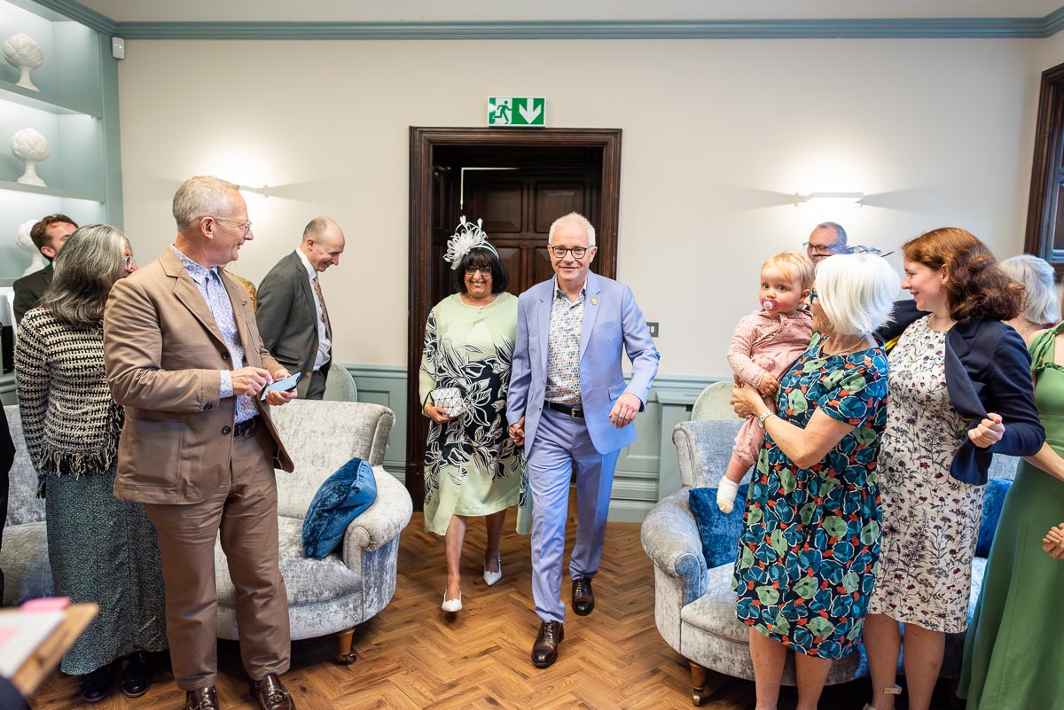 Ashifa and Julian walk down the aisle  surrounded by guests at Lewes Register Office