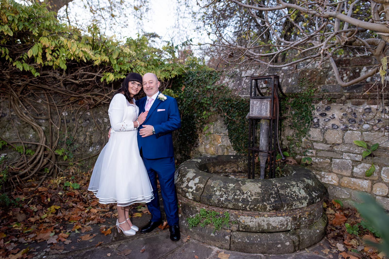 Andy and Caron pose at the well in Southover Grange, Lewes.