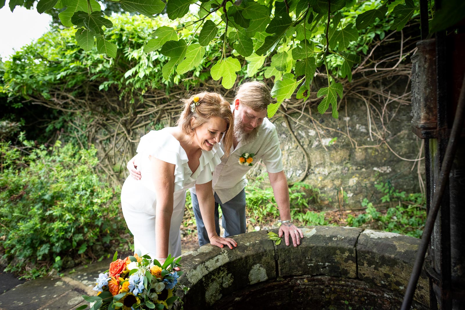 Mary and Mark look into the well at Southover Grange in Lewes