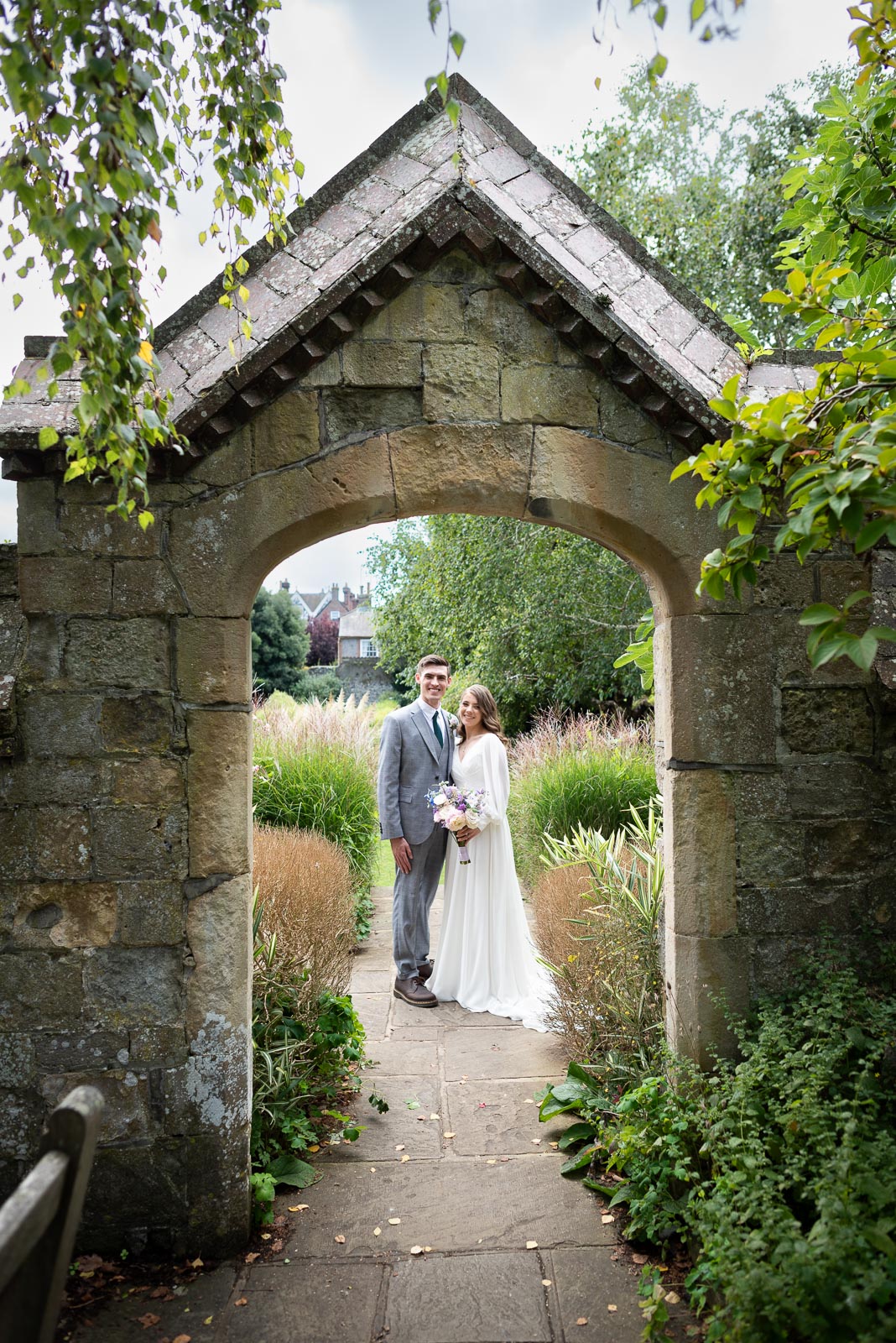 Mark and May pose in one of the historic arches at Southover Grange in Lewes