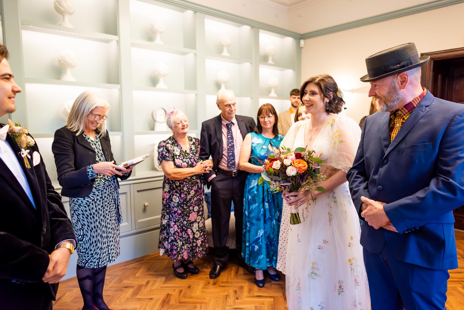 Lola arrives arm in arm with her father in the Ainsworth Room at Lewes Registry Office before her wedding to Laurence, just captured on the left hand side.