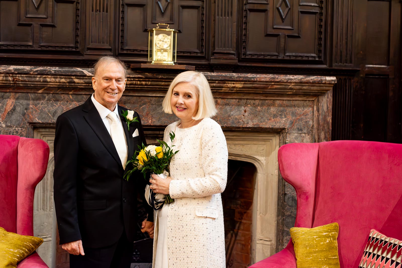 Peter and Dawn photographed in the atrium at Lewes Registry Office on front of the glorious fireplace.