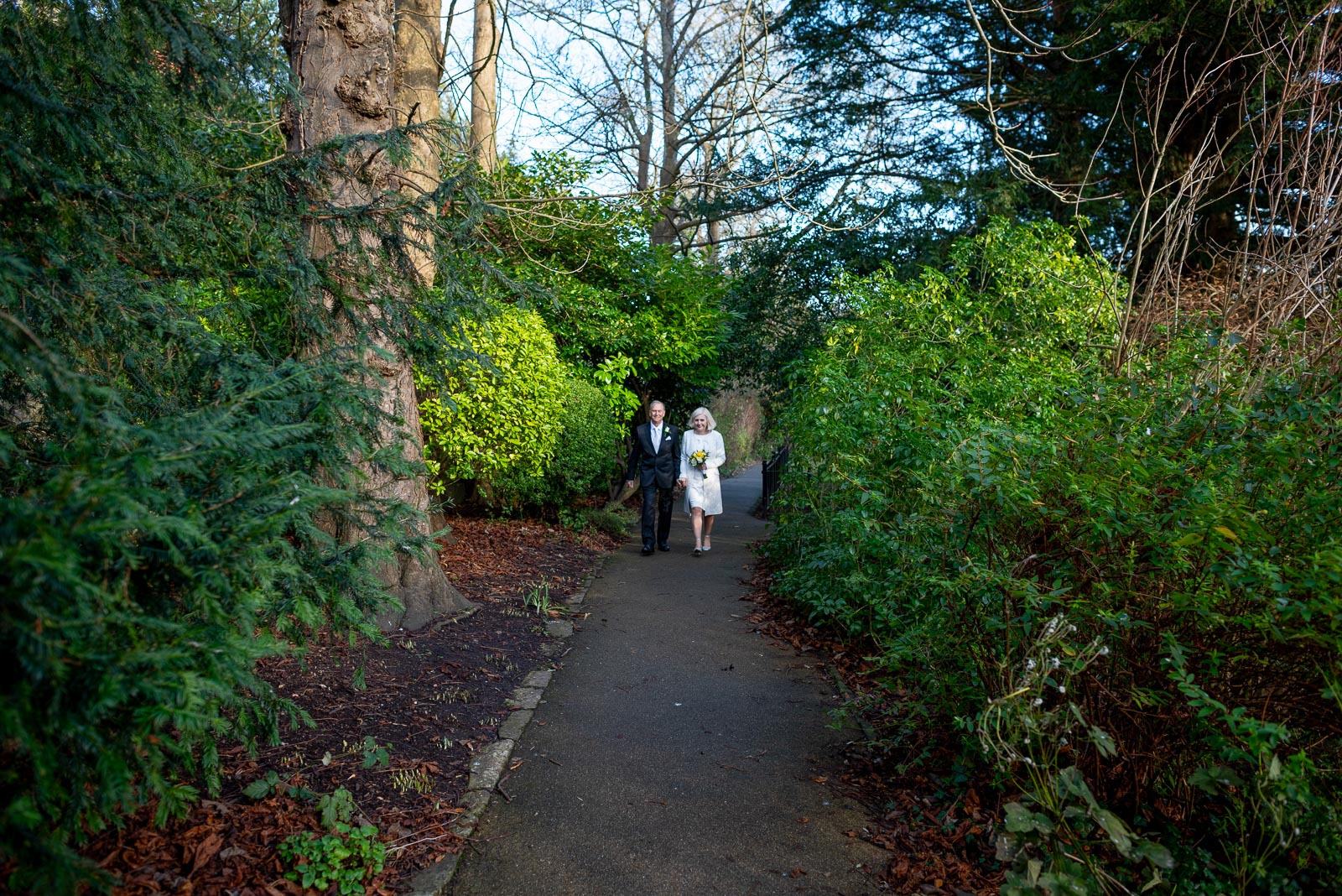 Peter and Dawn walk through Southover Grange after their wedding at Lewes Registry office. 