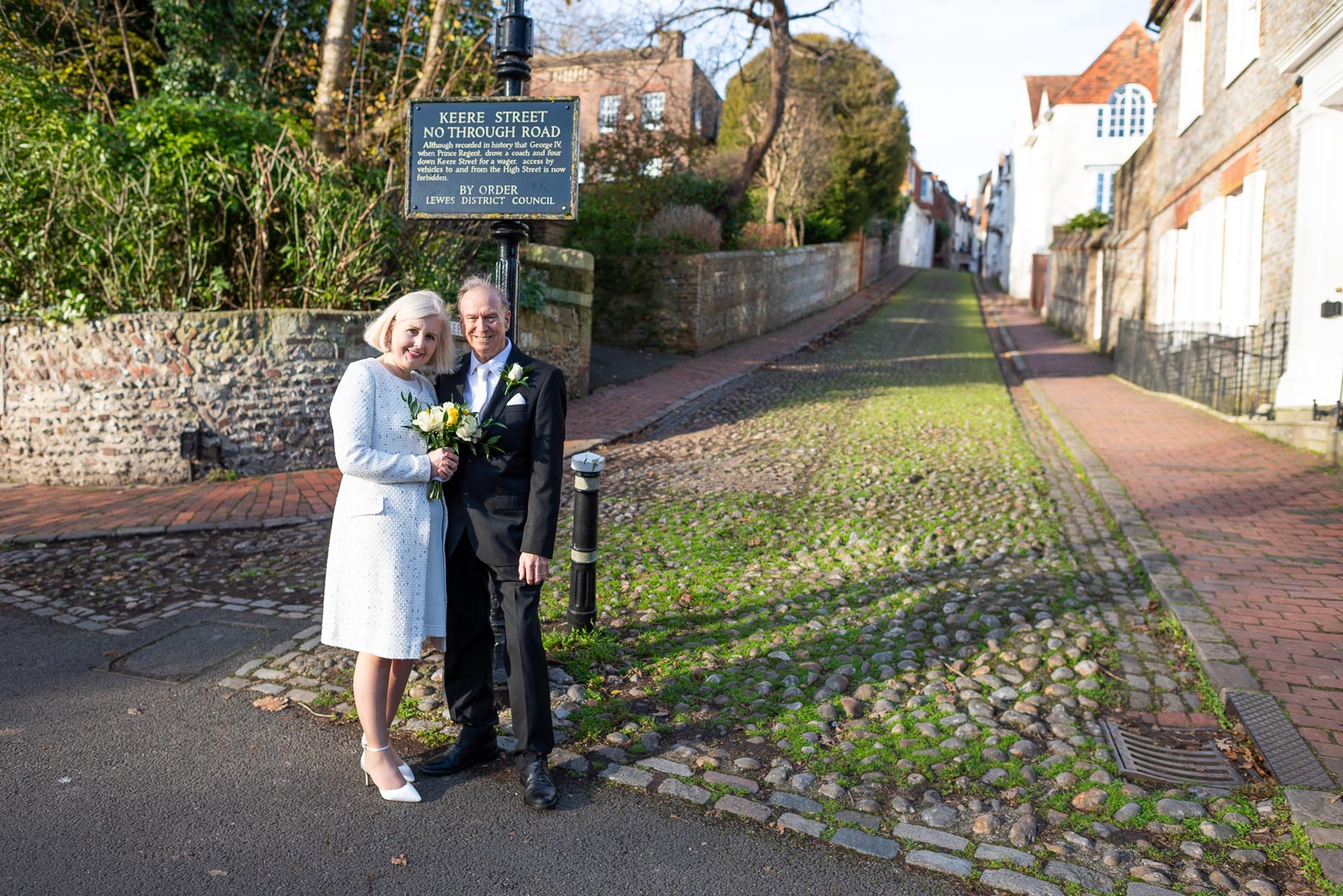 Peter and Dawn smile at the bottom of Keere Street in Lewes after their wedding in Lewes Registry Office.