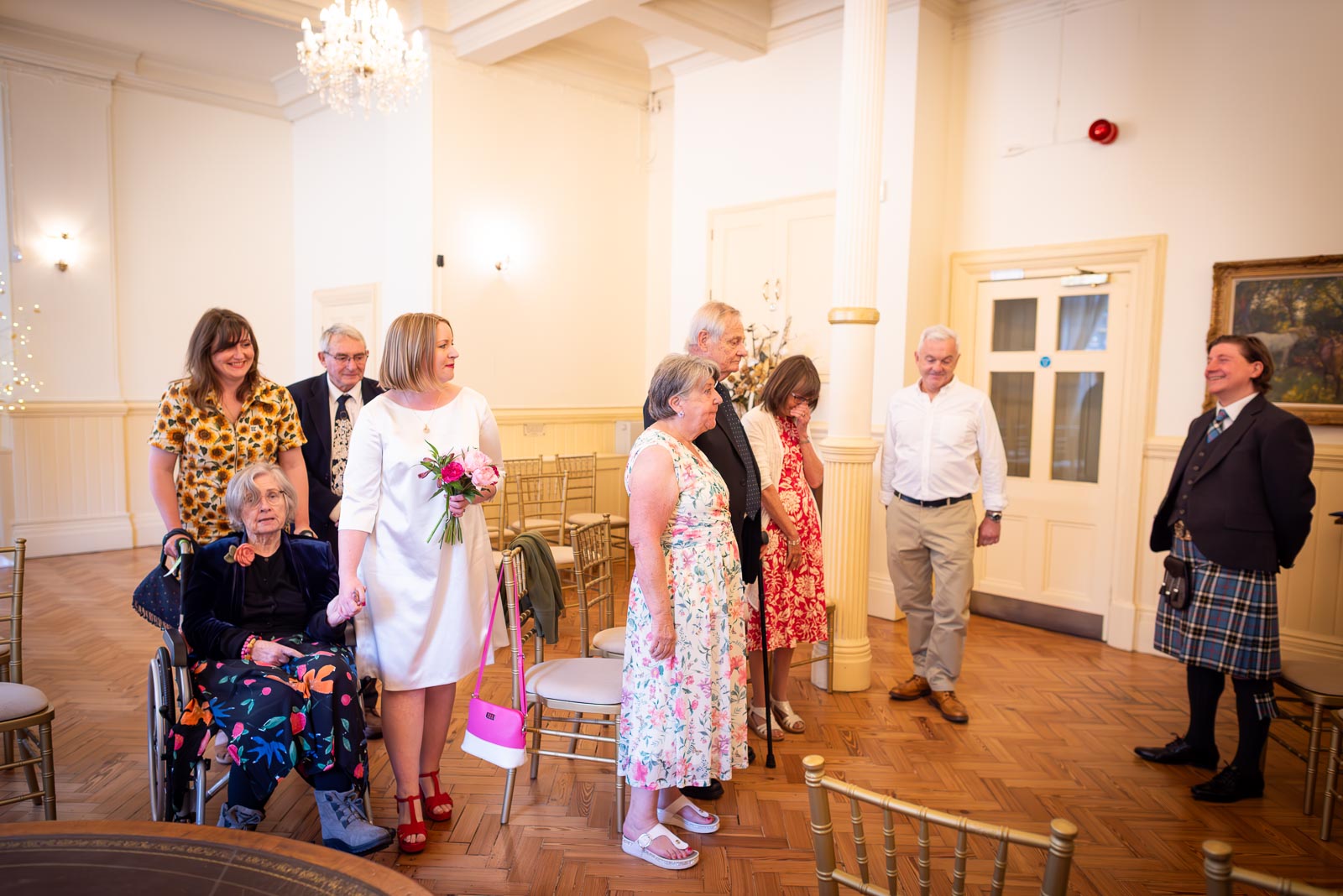 Clare arrives hand in hand with her mum in the Regency Room at Brighton Town Hall before her civil partnership to Sam.