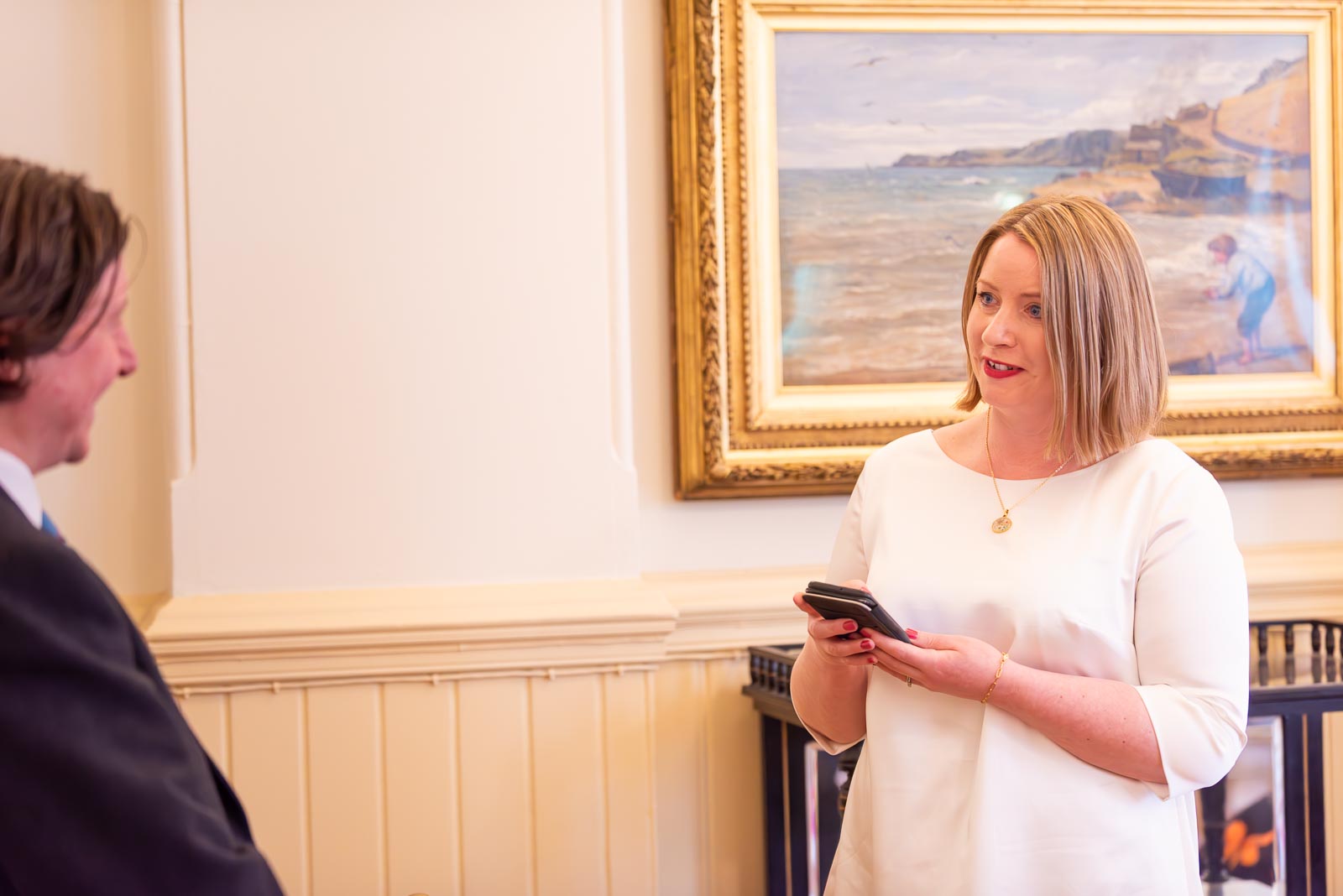 Clare reads a handwritten note to Sam during their Civil Partnership in the Regency Room at Brighton Town Hall. 
