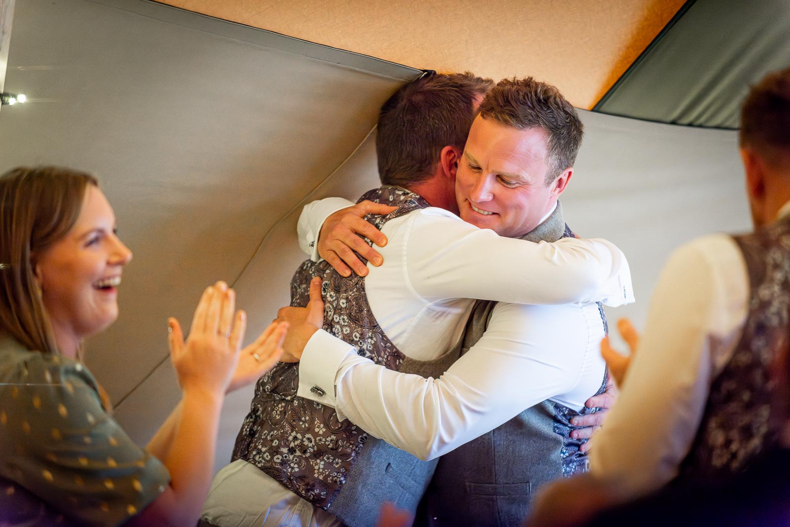 Marc embraces his best man and twin brother following the speeches at the Party Field near Lewes.