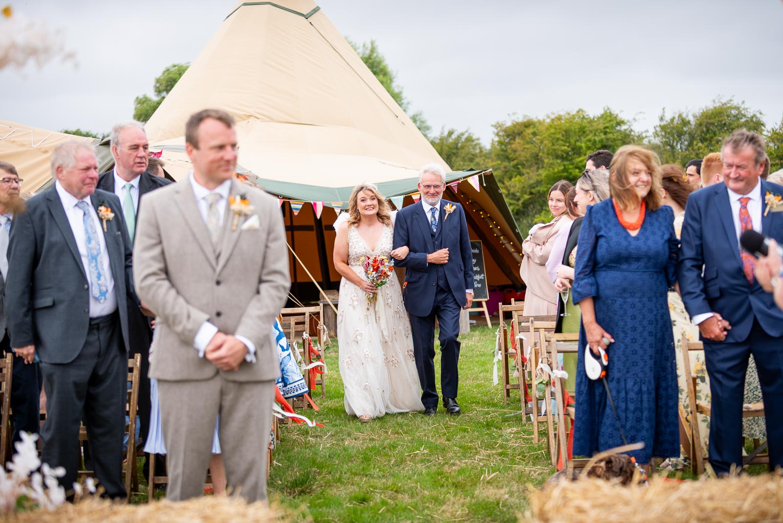 Eleanor arrives accompanied by her father on the aisle at the Party Field near Lewes before her wedding to Marc.