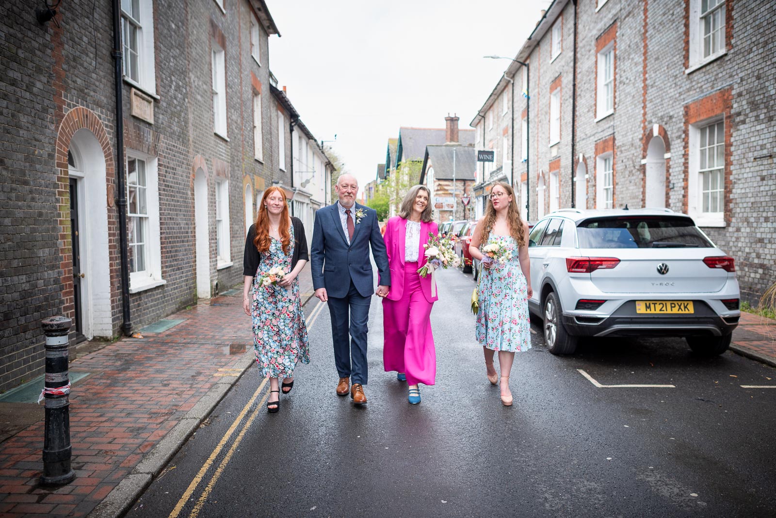 Helen and Tony walk through Lewes with their daughters following their wedding