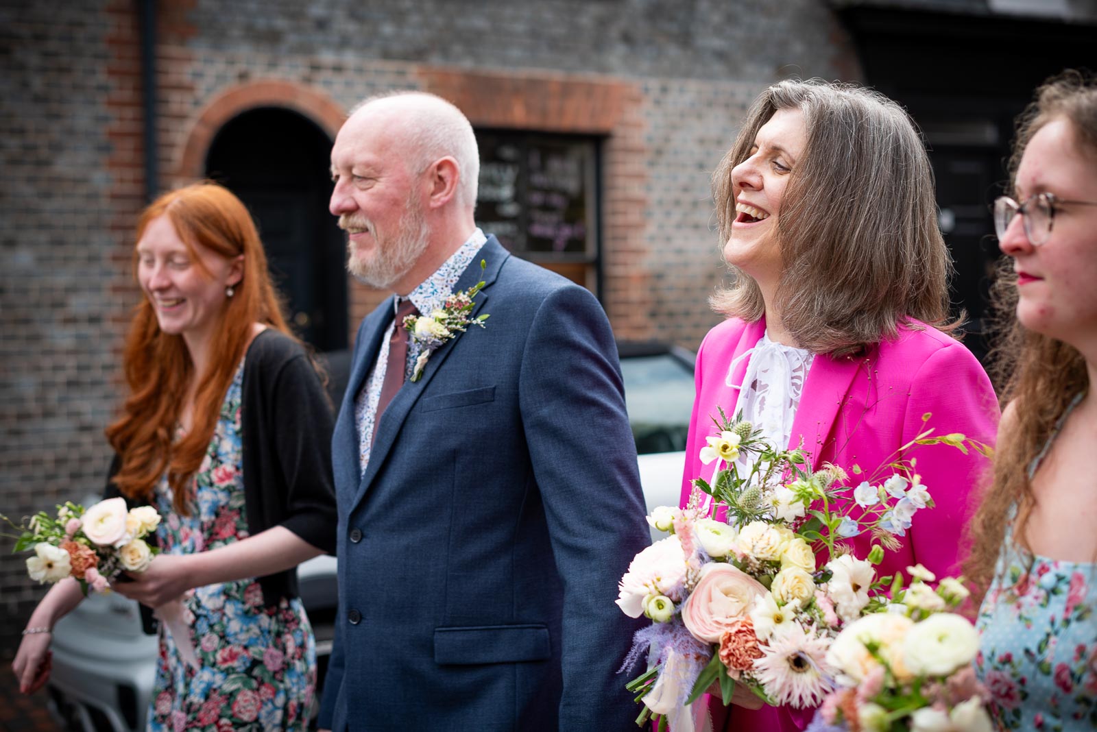 Helen and Tony walk through Lewes with their daughters following their wedding