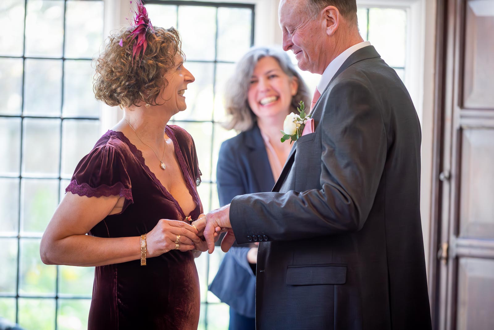 Jill makes sure John's ring is on during their wedding in the Ainsworth Room at the Lewes Registry Office