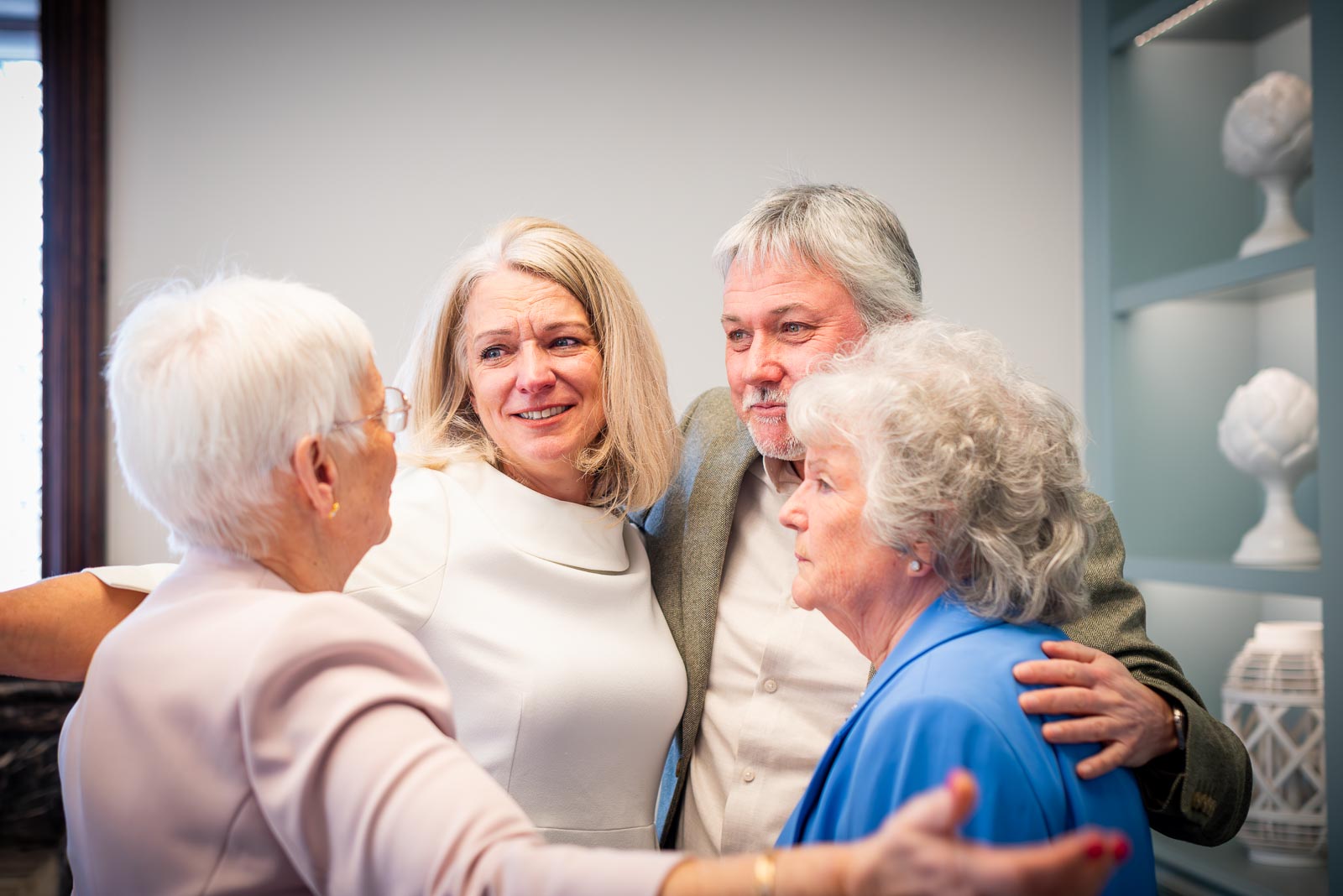 Jo and Darren hug their mum's after getting married in the Evelyn Room at Lewes Registry Office
