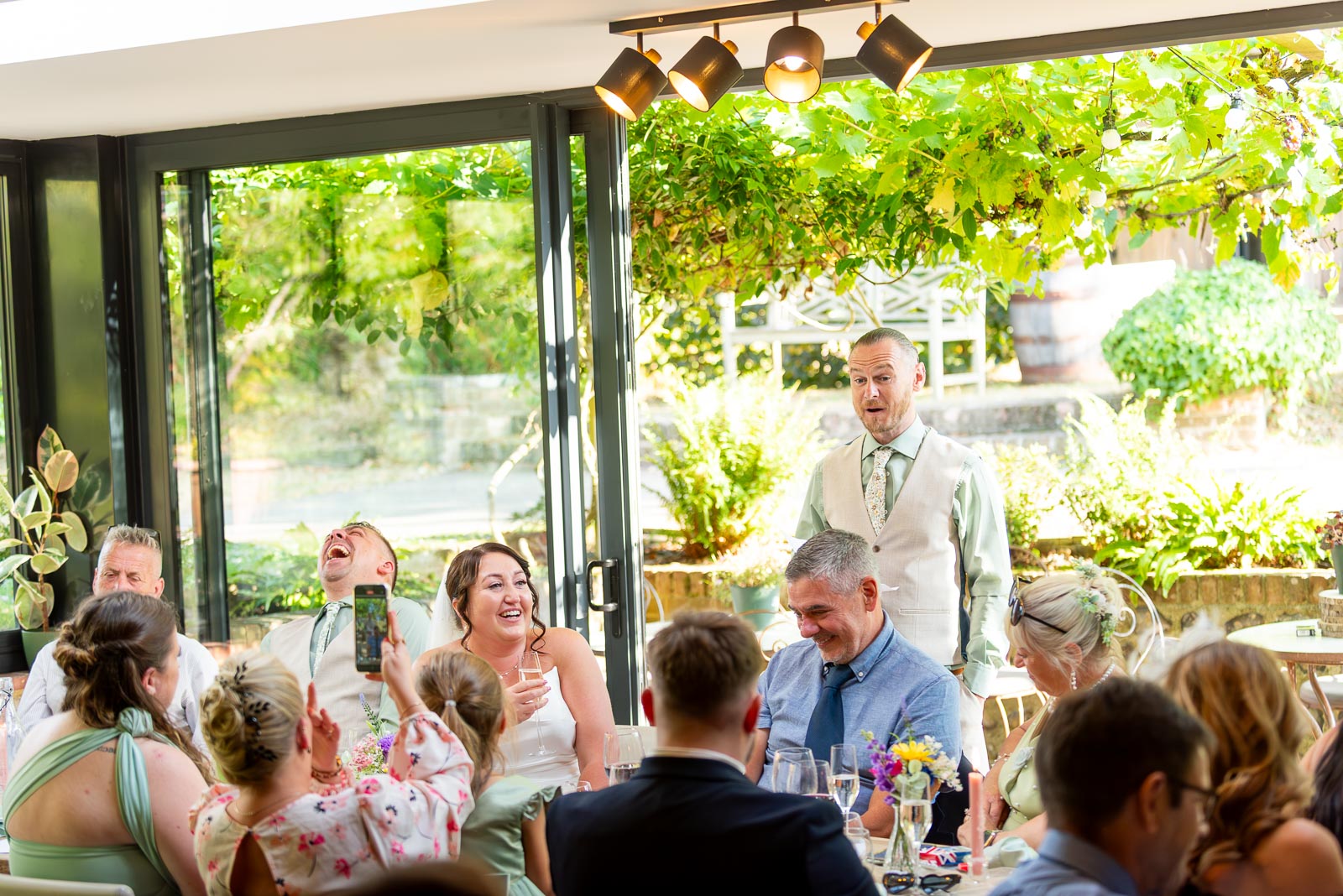 Karl's best man provides the guests with a hilarious anacdote during his speech at the wedding reception at The Jolly Sportsman in Chiltington near Lewes. 