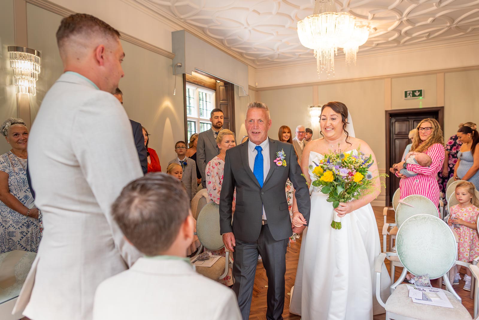 Tamsyn walks down the aisle accompanied by her dad in the Ainsworth Room at Lewes Registry Office before her wedding to Karl.