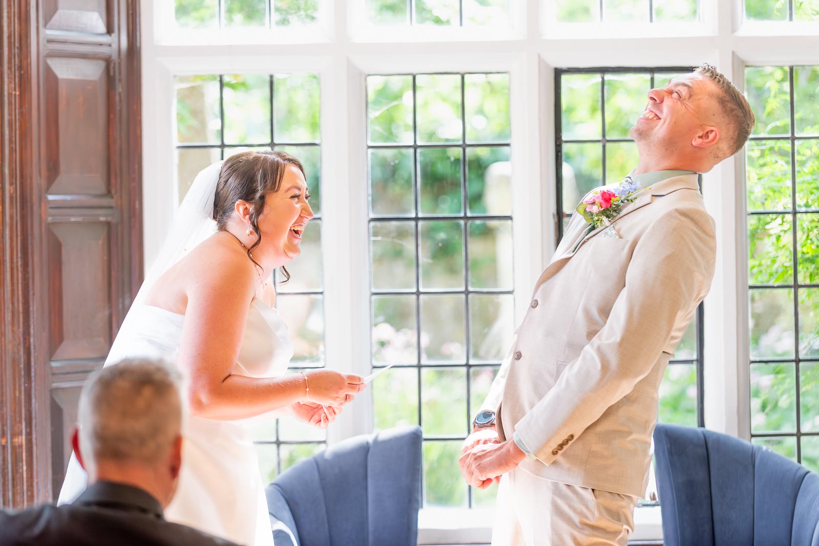 Tamsyn and Karl enjoy a funny moment in the Ainsworth Room at Lewes Registry Office during their vows.