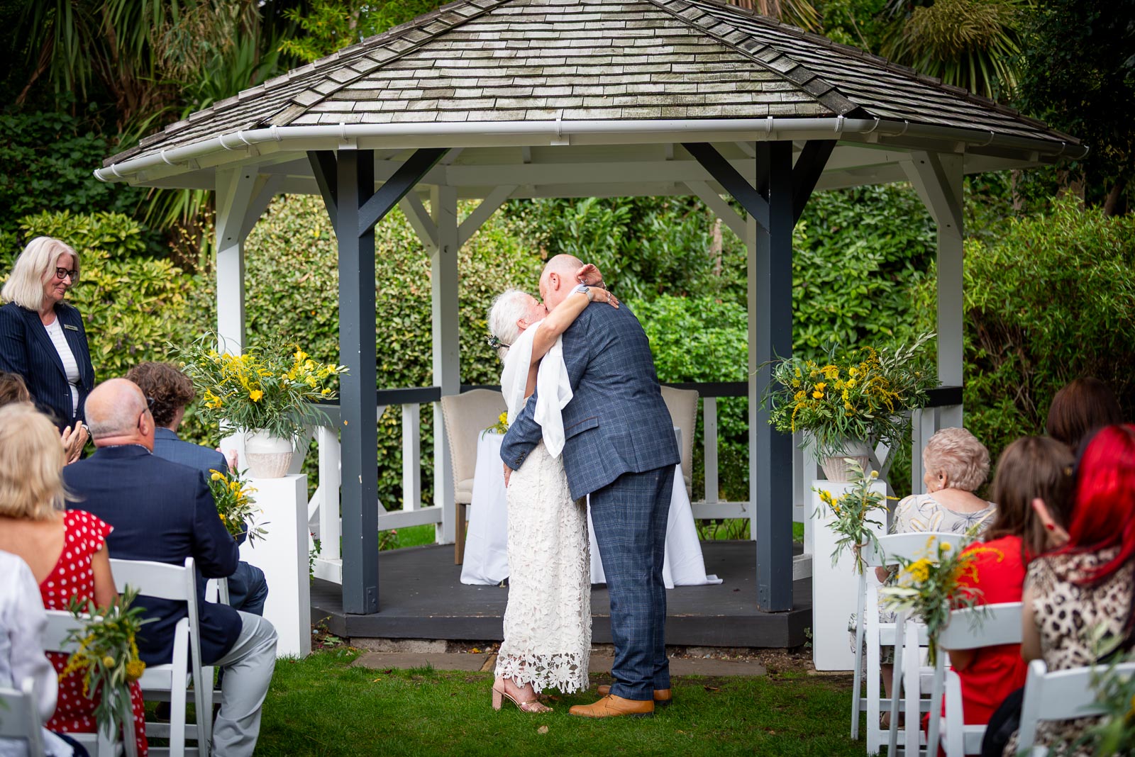 Karen and Hugh kiss at the bottom of the aisle after their wedding in the Gardens at Pelham House Hotel, Lewes.