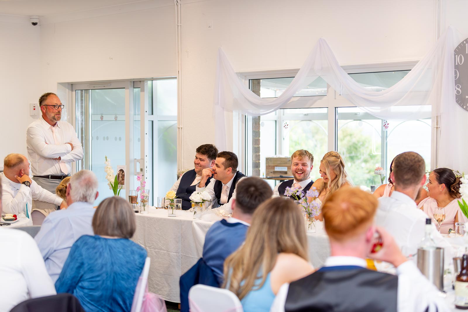 Shannon's dad makes the wedding guests laugh during the speeches at Eastbourne Downs Golf Club during the wedding reception.