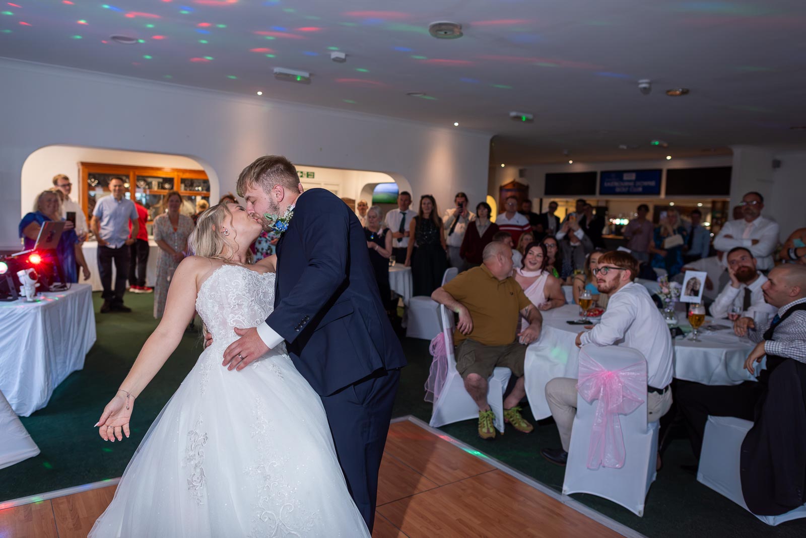Brandon dips and kisses Shannon during their first dance at Eastbourne Downs Golf Club during the wedding reception.